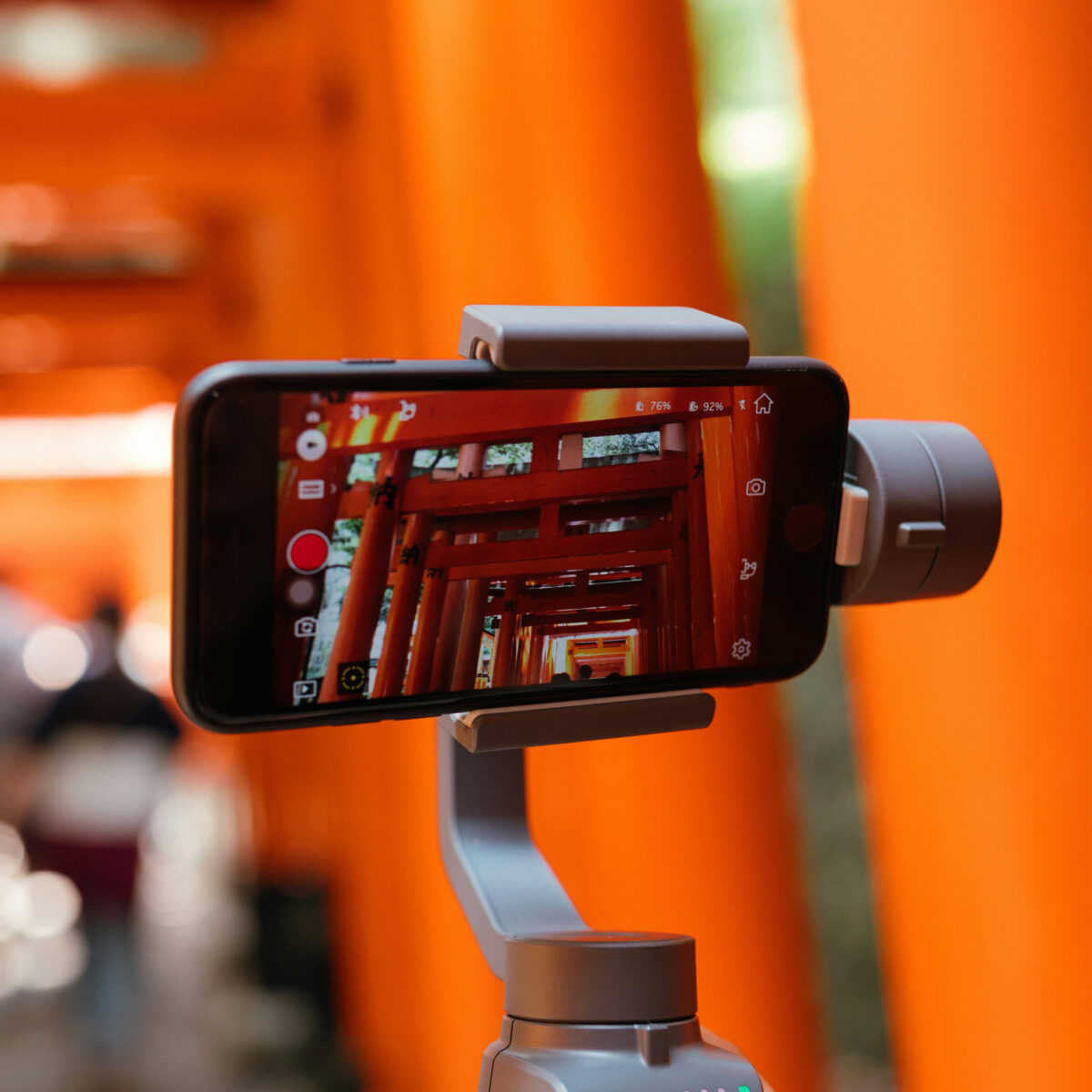 A phone mounted on a gimbal, recording video of a building